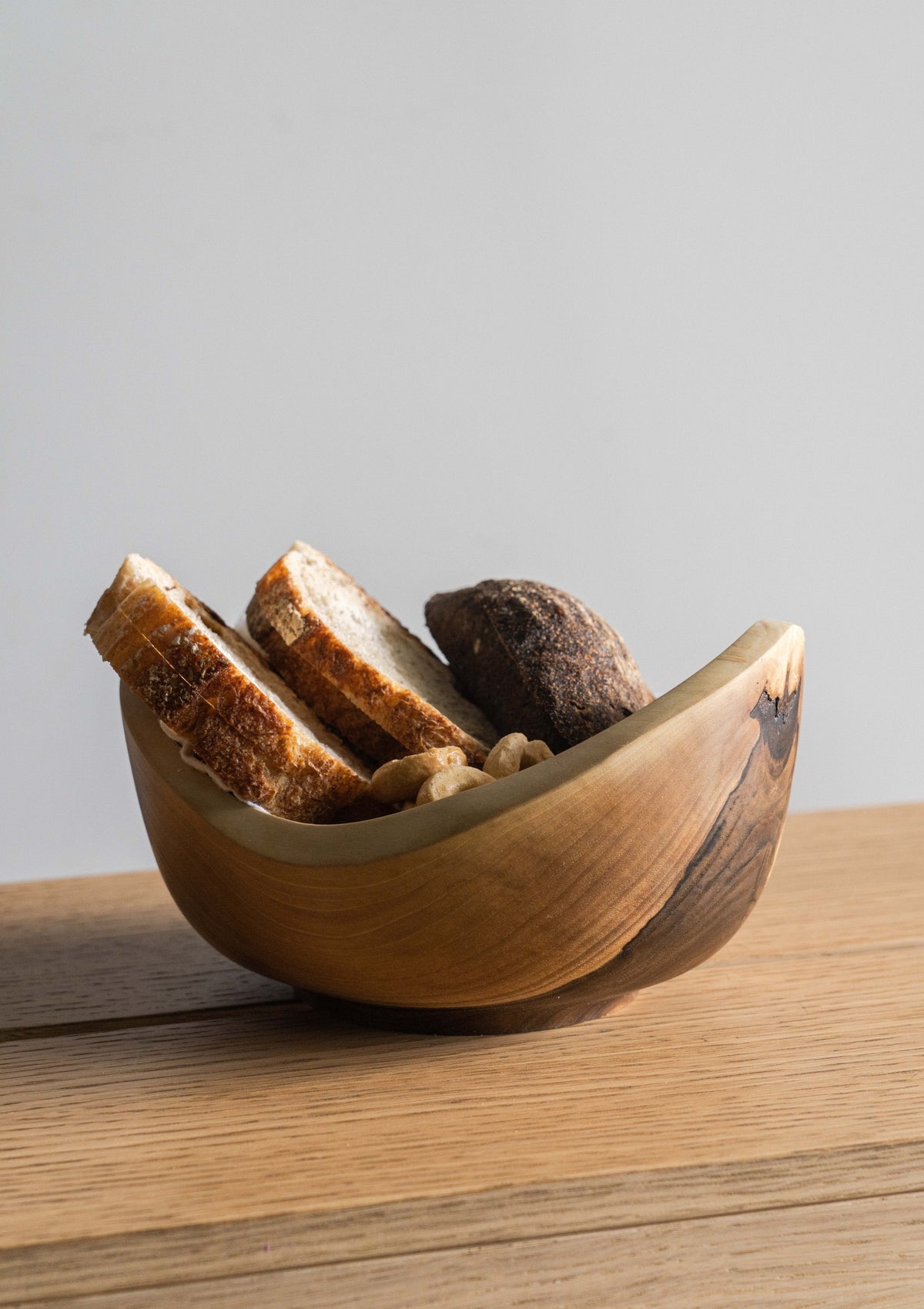 Hand carved small wooden walnut bowl with natural wood grain and oil finish