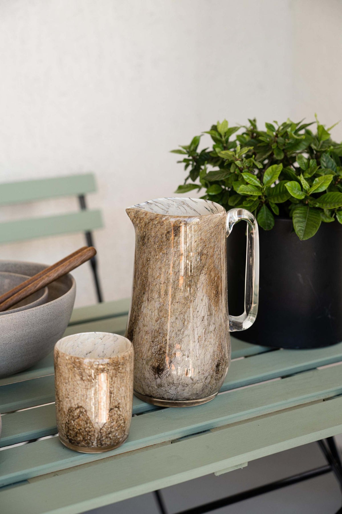 Elegant hand blown glass pitcher with marble pattern and sturdy handle for water, drinks, or flowers