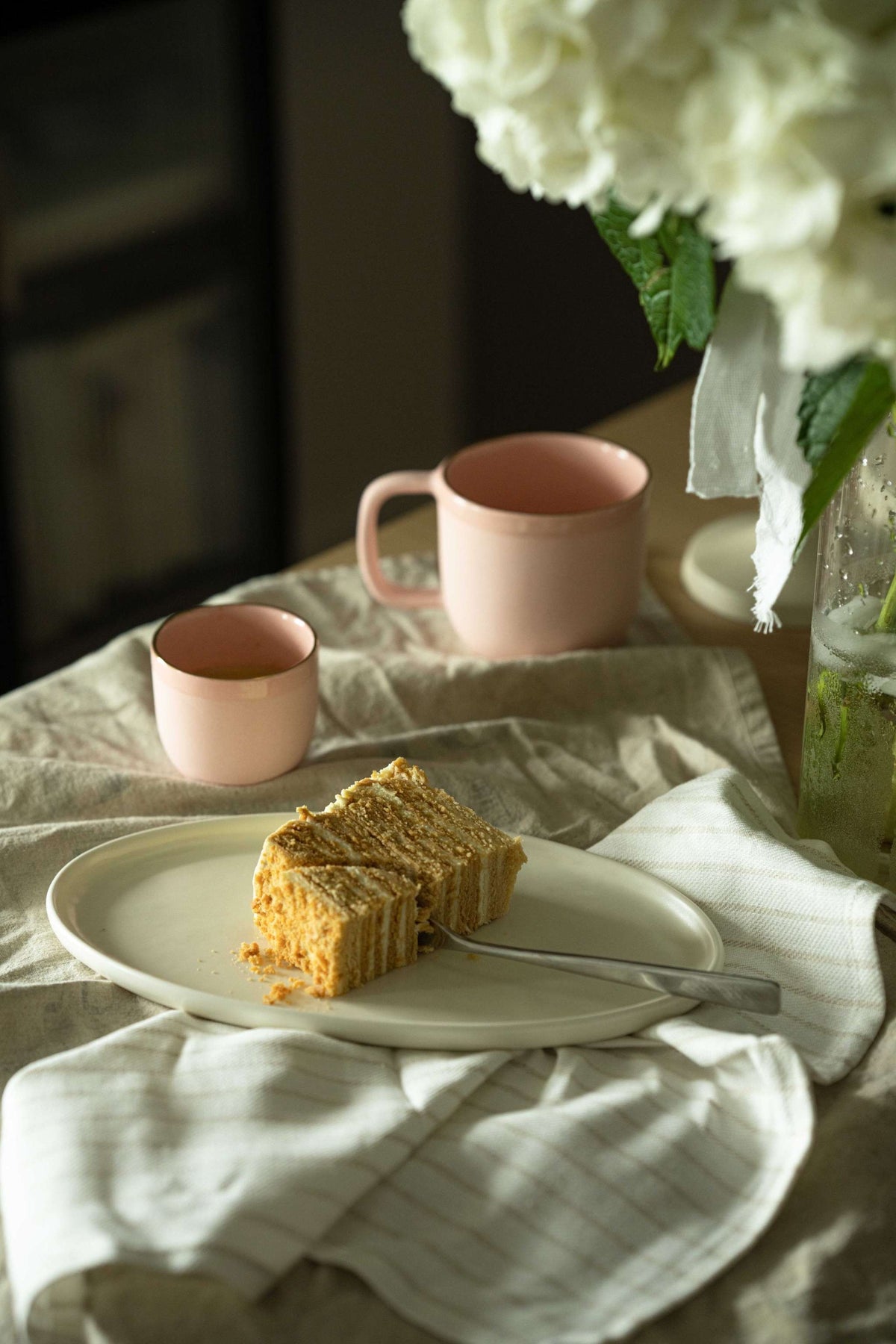 White matte stoneware oval serving platter with organic edges, handmade and food-safe