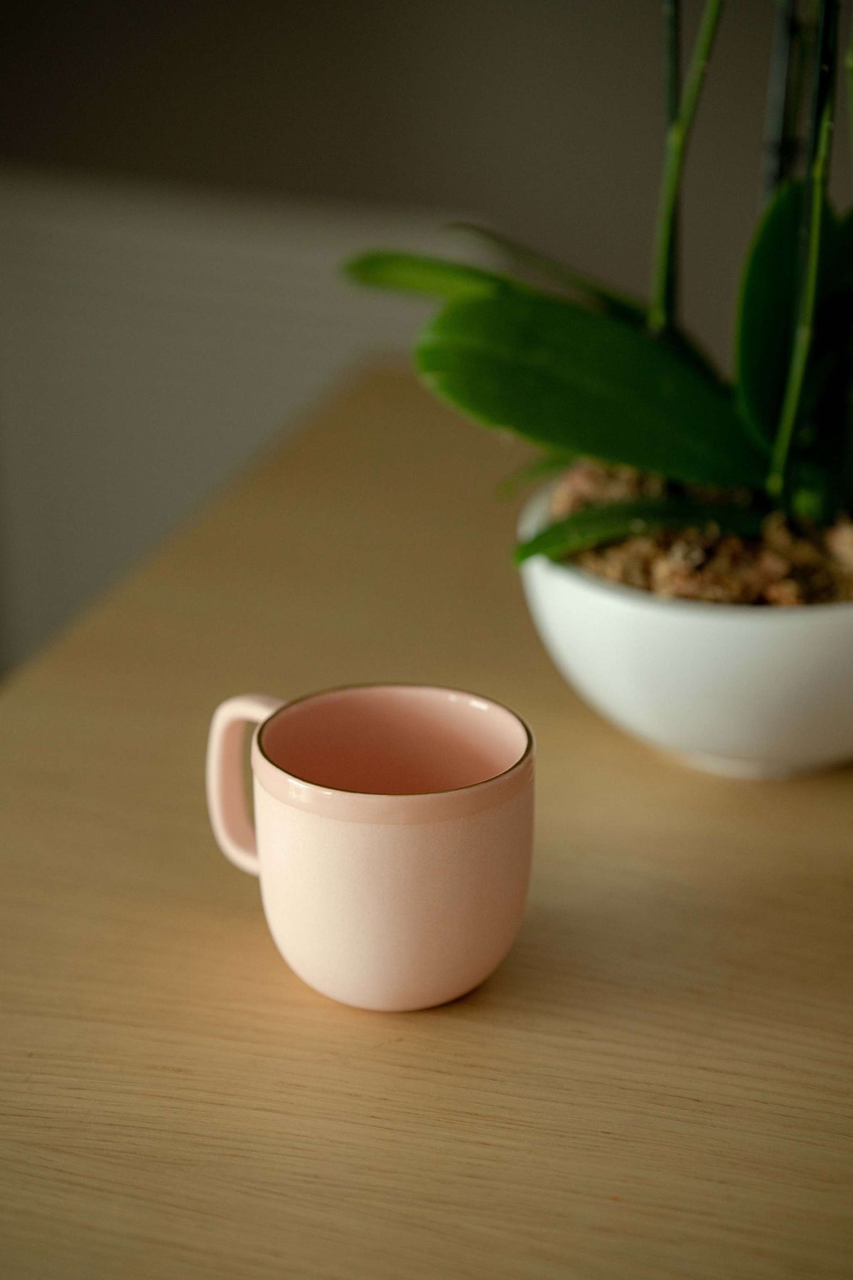 Handmade porcelain coffee mug in powder pink with gold rim and glossy glaze