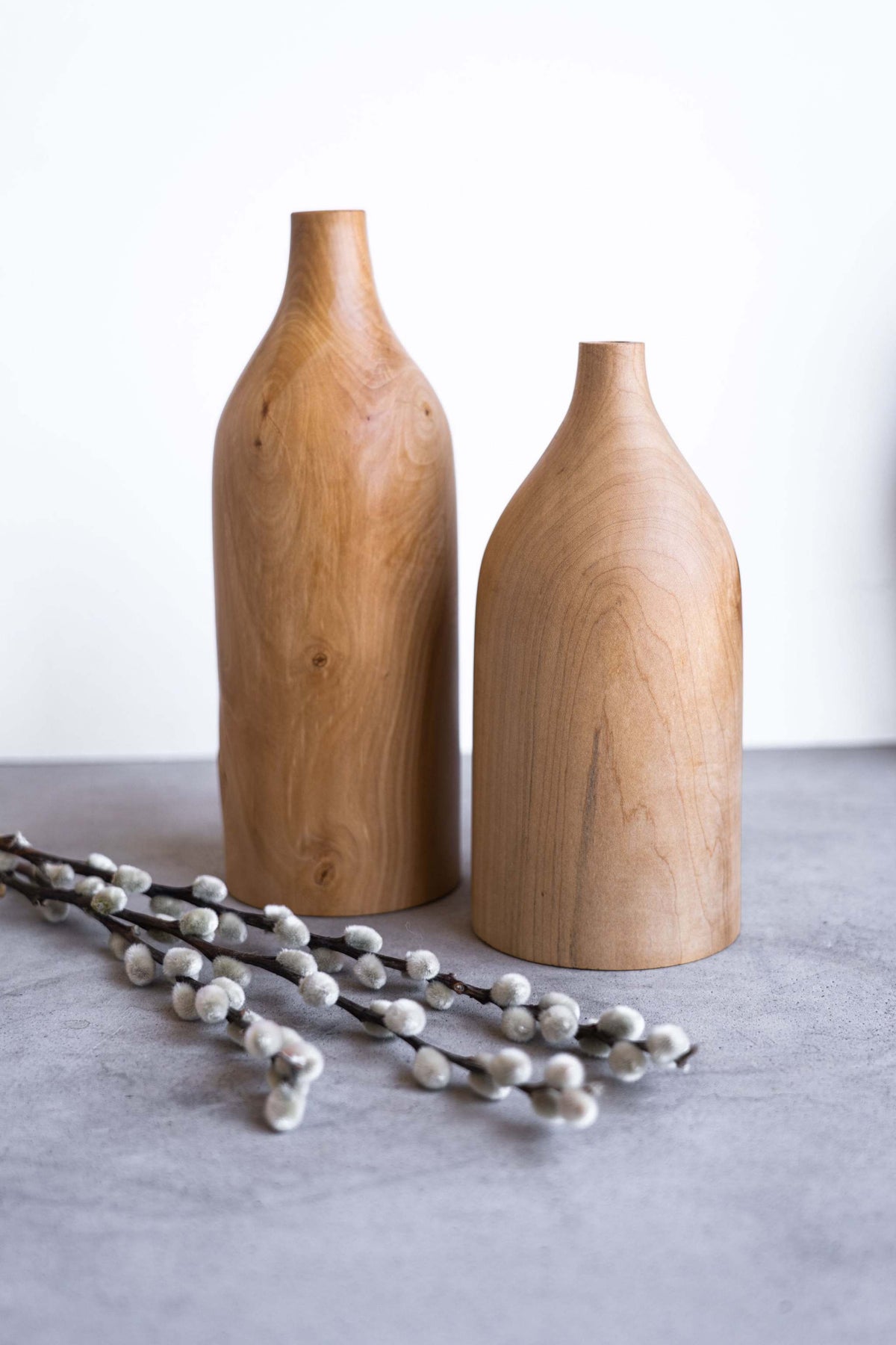 Handcrafted pear wood bottle-shaped vase with natural grain patterns and smooth finish, elegant home decor piece