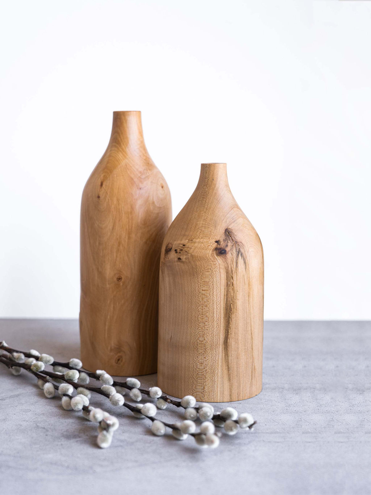 Handcrafted pear wood bottle-shaped vase with smooth finish and natural grain patterns for elegant home decor