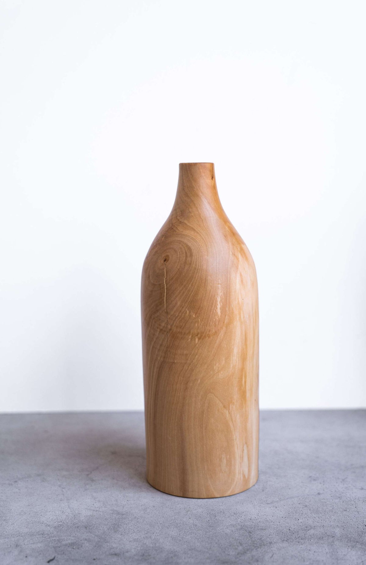 Handcrafted pear wood bottle-shaped vase with natural grain and smooth finish, rustic modern home decor