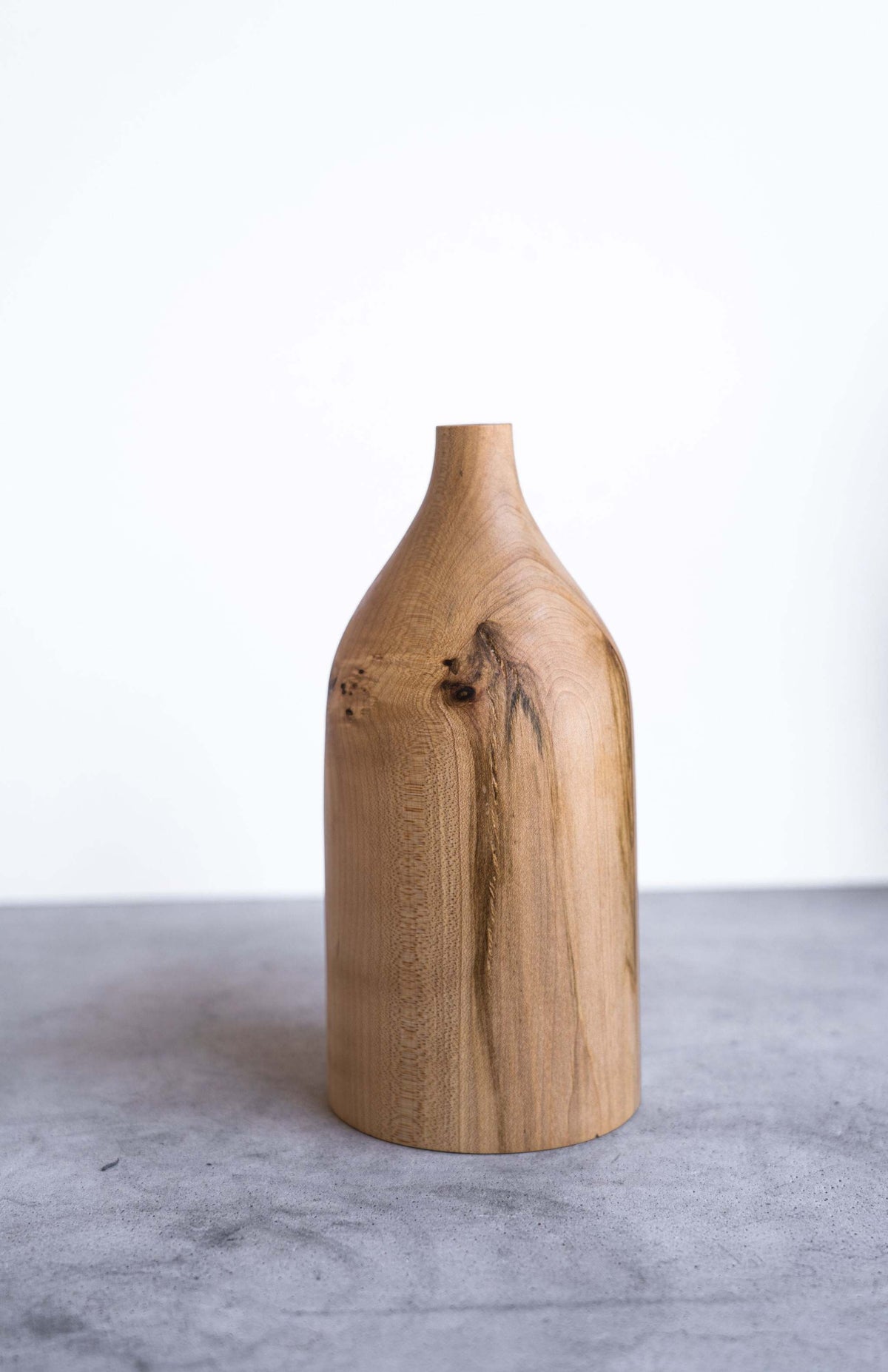 Handcrafted pear wood bottle-shaped vase with natural grain and smooth finish