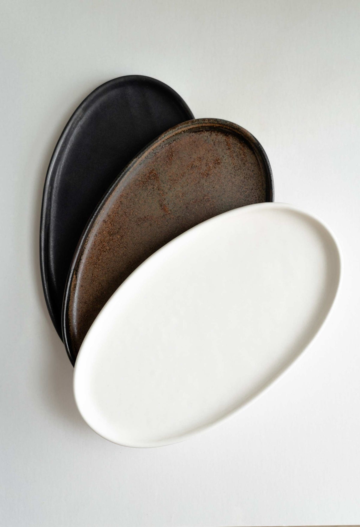 White matte stoneware oval serving platter with organic edges and reactive glaze, handmade in Ukraine