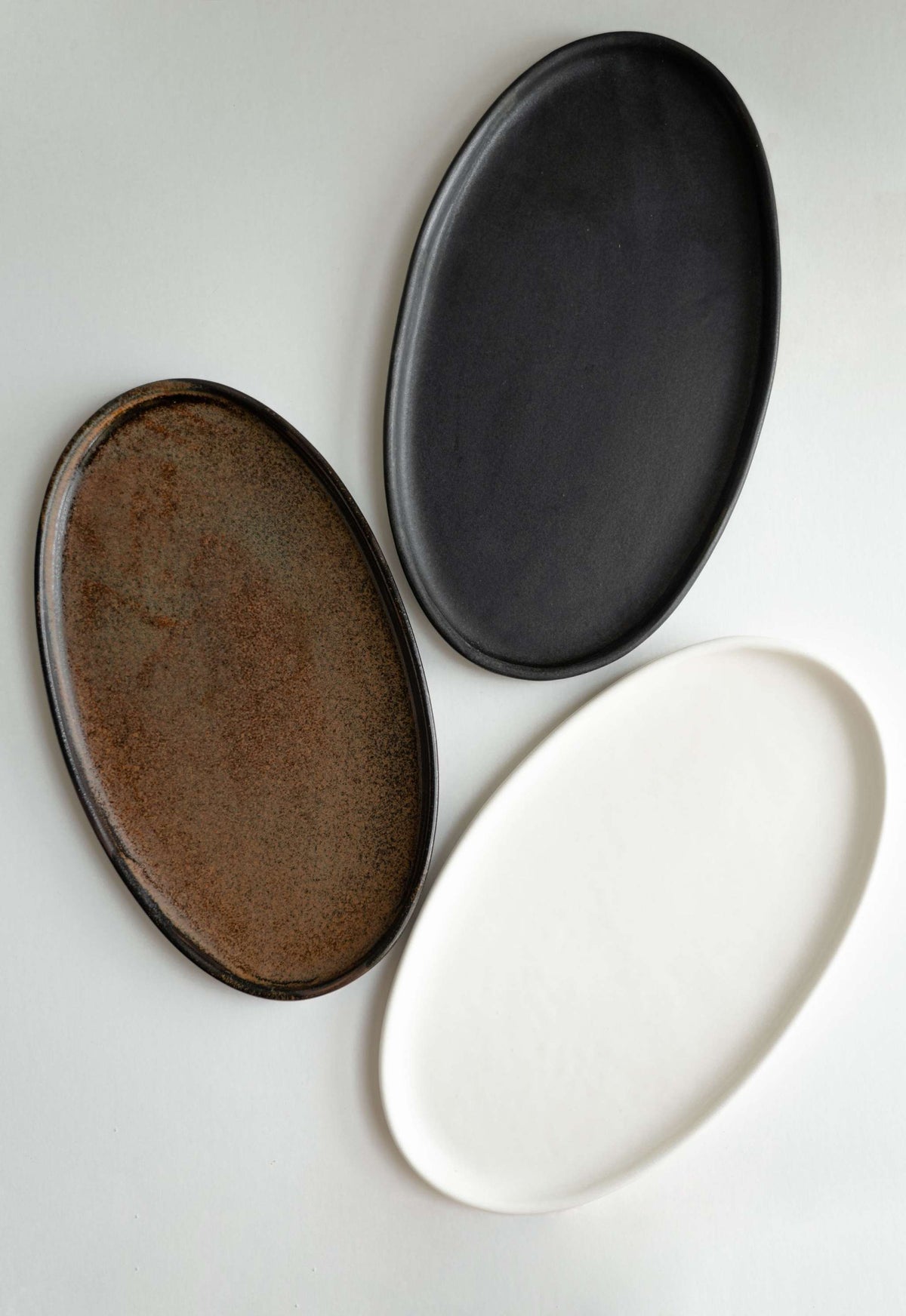 Handmade black matte stoneware oval serving platter with food-safe glaze and organic edges