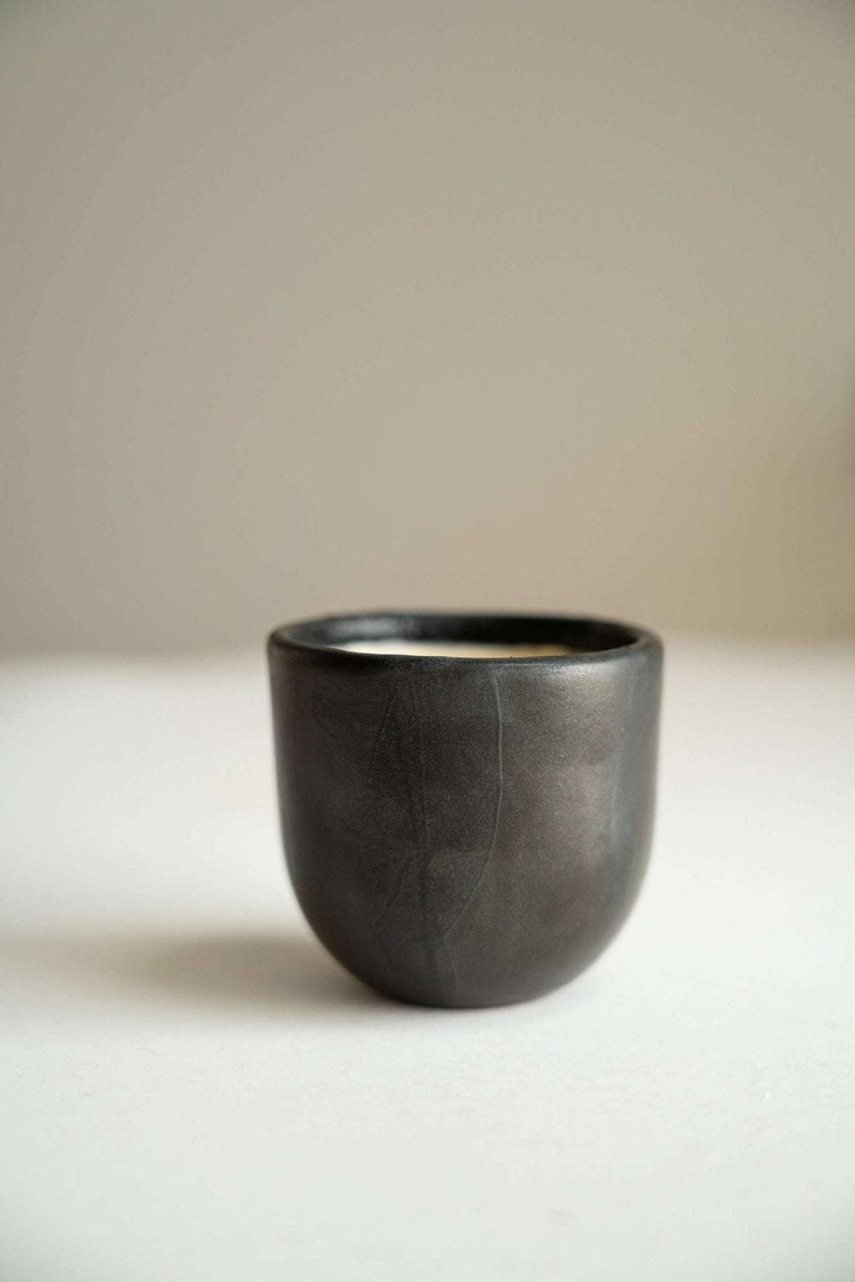 Handmade black stoneware espresso cup with reactive glaze and organic edges, 5 oz, dishwasher-safe, made in Ukraine