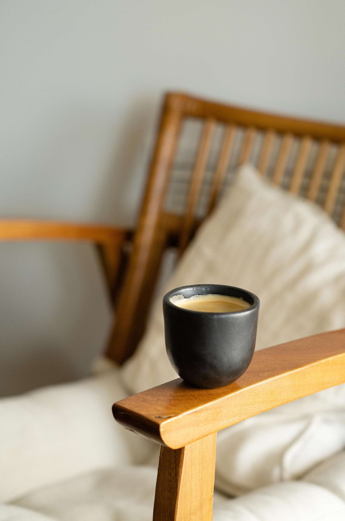 Handmade black stoneware espresso cup with organic edges and reactive glaze, dishwasher and microwave safe