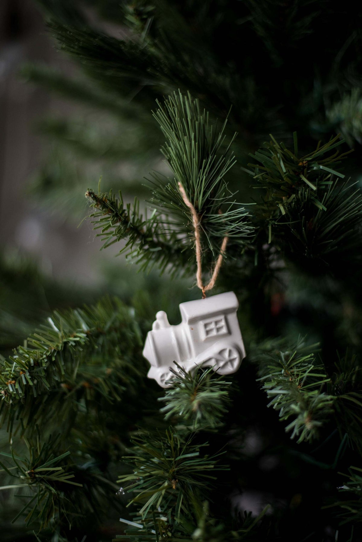 Handmade white porcelain Christmas ornaments with jute hanging loops, rustic holiday decor from Ukraine