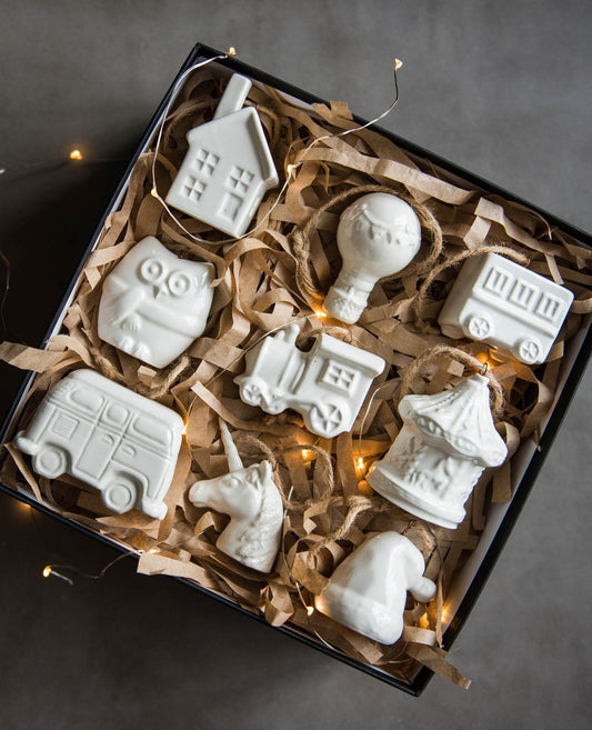 Handmade porcelain Christmas tree ornaments with jute loops, smooth glazed finish, rustic holiday décor from Ukraine