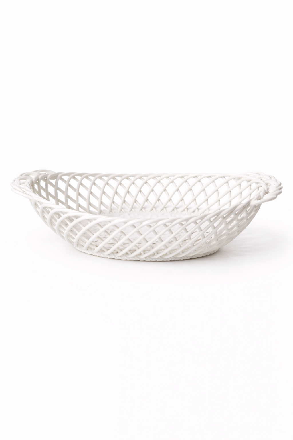 Ceramic Oval Basket in glossy white porcelain, with an airy hand-woven lattice and sculptural oval shape.