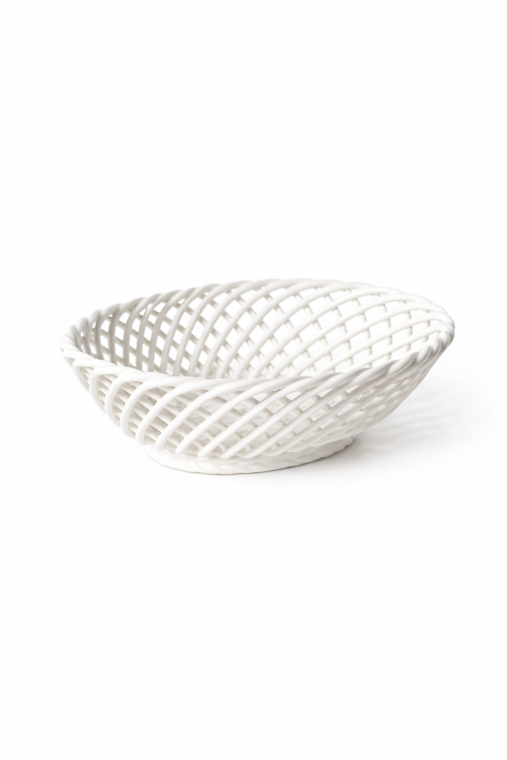 Hand-Woven Ceramic Basket, a white glossy porcelain dish with an airy oval shape and interlacing woven strips.