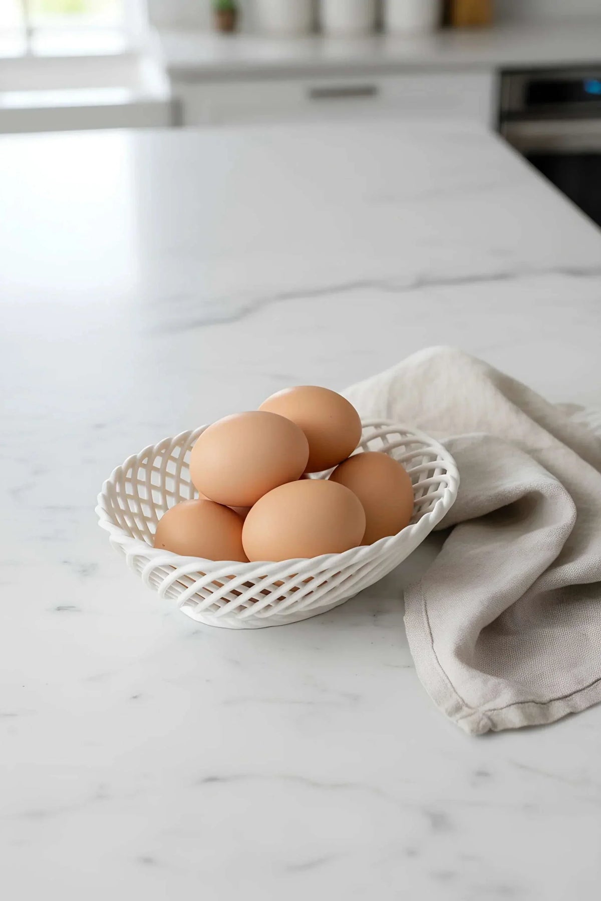 Hand-Woven Ceramic Basket in glossy white porcelain, with an oval shape and airy interlaced woven design.