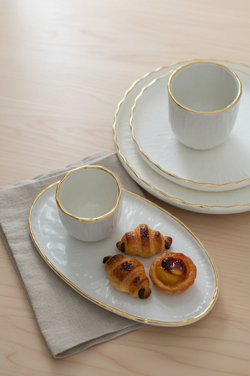 Handmade porcelain dinner plates with gold rim and relief texture from the Relief Collection