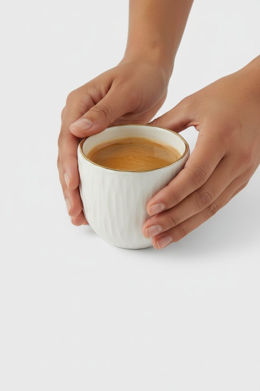 Handmade white porcelain coffee cup with gold rim from Relief Collection