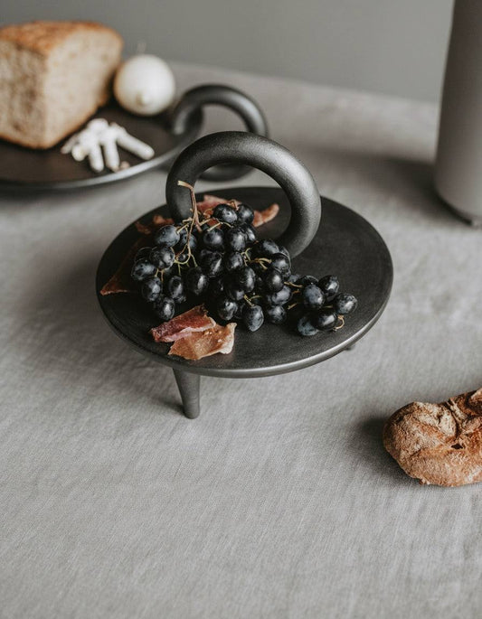 Small black smoked ceramic pedestal platter handcrafted in Ukraine by Danuta Kril