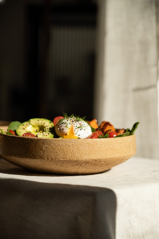 Handmade stoneware breakfast bowl in yellow clay with natural speckles and glazed interior