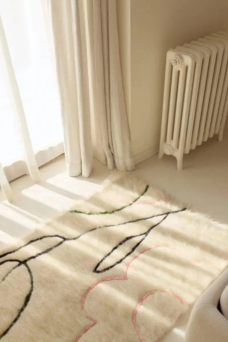Handwoven wool runner rug with creamy brushed texture and delicate floral outlines handcrafted in Ukraine