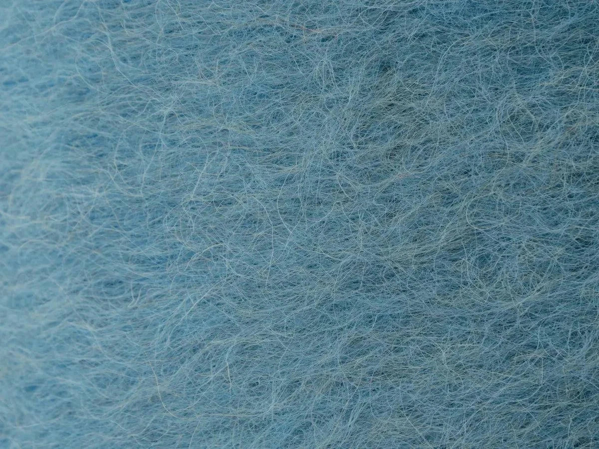 Sky blue handwoven wool pillow with brushed texture and natural Carpathian sheep wool on cotton base