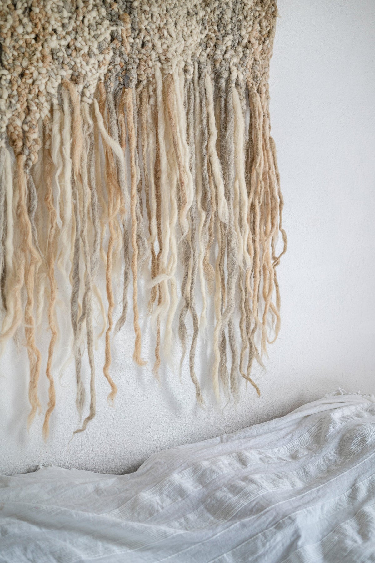 Handwoven wool wall hanging with textured neutral design made in Ukraine