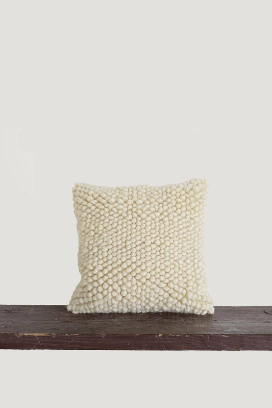 Handwoven wool decorative pillow with chunky yarn and oversized pattern in neutral tones