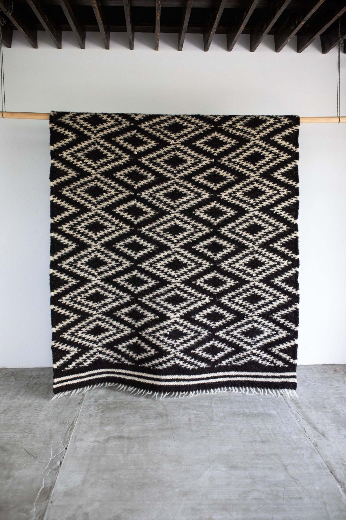 Traditional Carpathian wool lizhnyk with spectacled pattern handwoven from 100% sheep wool, used as bedspread or carpet