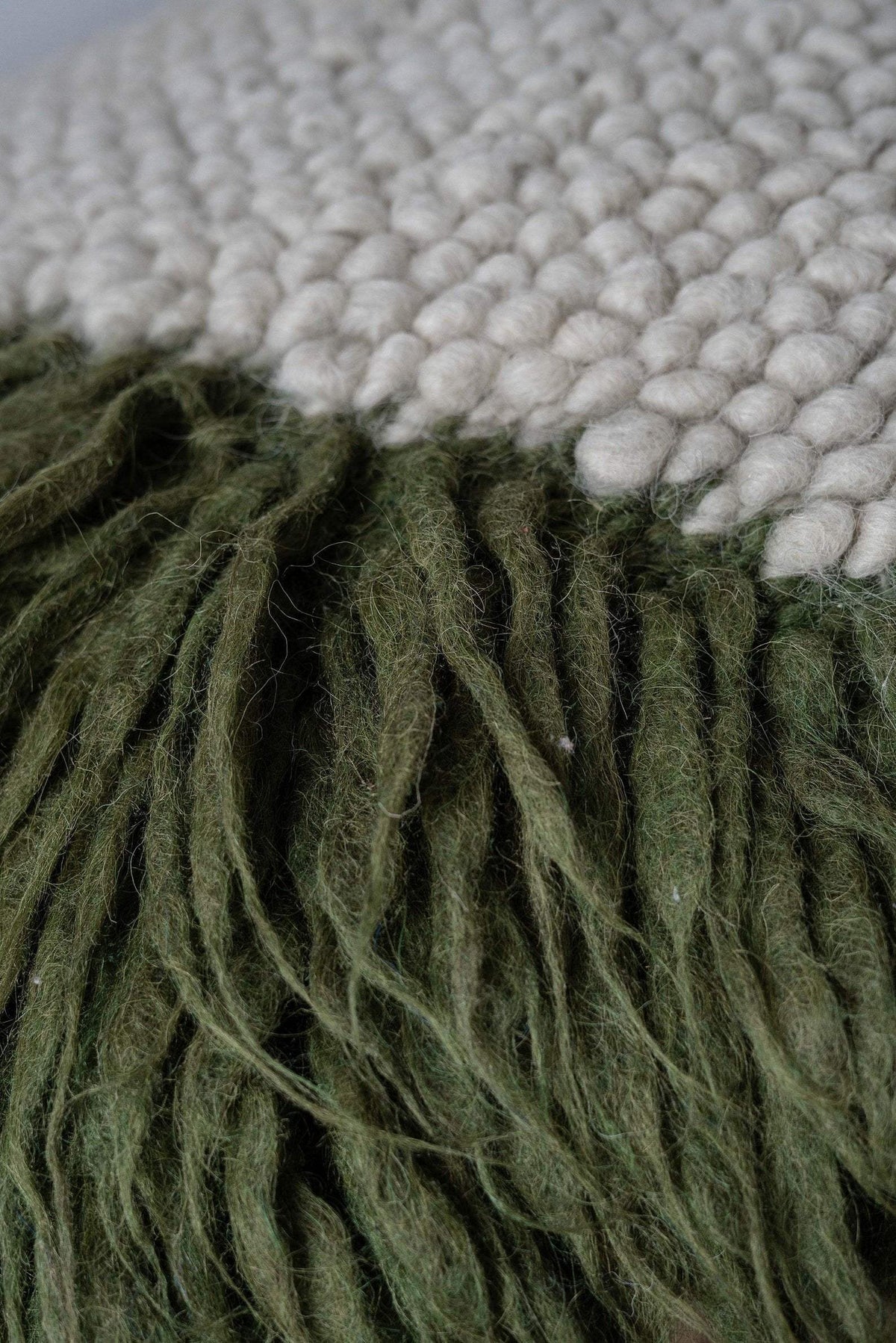 Handwoven pillow Forest Moss made of chunky wool yarn with fluffy filling in oversized pattern