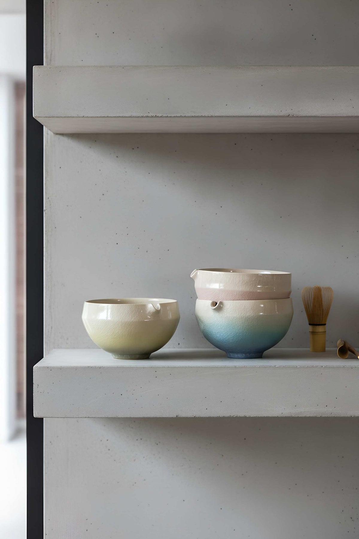 Ceramic Matcha Bowl, cream stoneware with a pale green glaze and pouring spout, beside a blue-gradient cup.