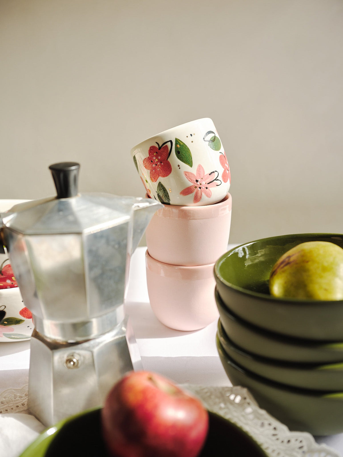 Hand-Painted Floral Coffee Cup, white porcelain mug with red and pink flowers, green leaves, and a gold rim.