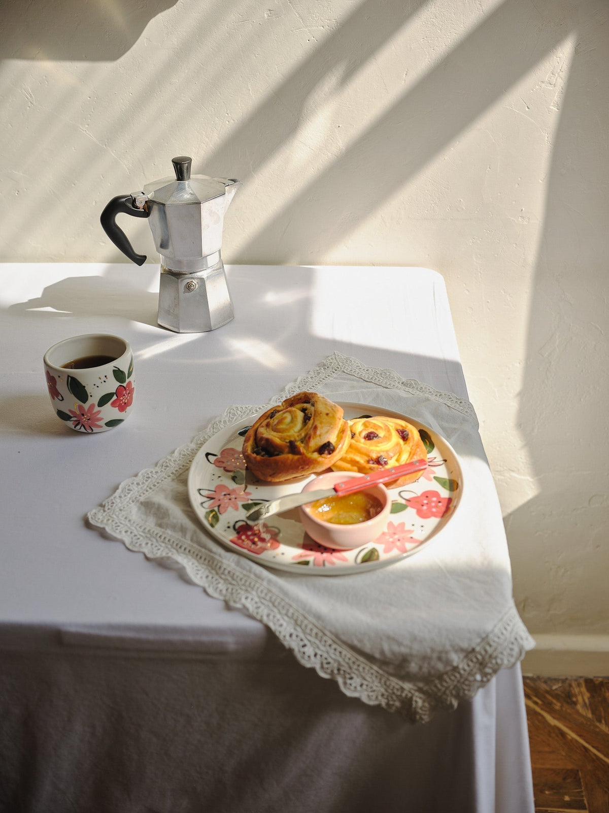Hand-Painted Floral Coffee Cup in off-white porcelain, decorated with red and pink flowers, green leaves, and a gold rim.