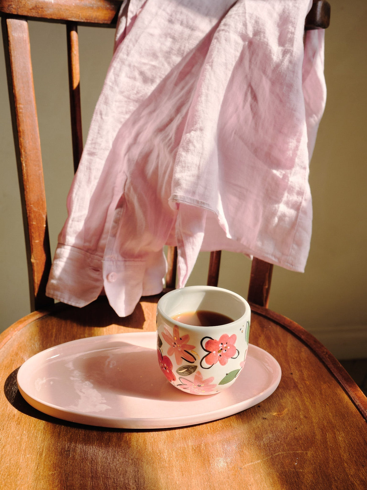 Hand-Painted Floral Coffee Cup in cream porcelain, decorated with pink and red blossoms, green leaves, and a gold rim.