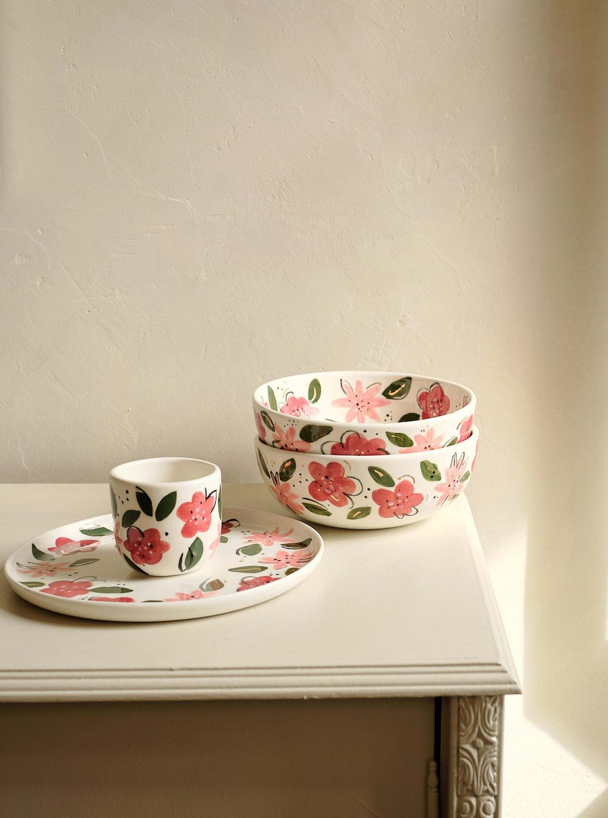 Hand-Painted Floral Coffee Cup, off-white porcelain with hand-painted pink and red flowers, green leaves, and gold accents.