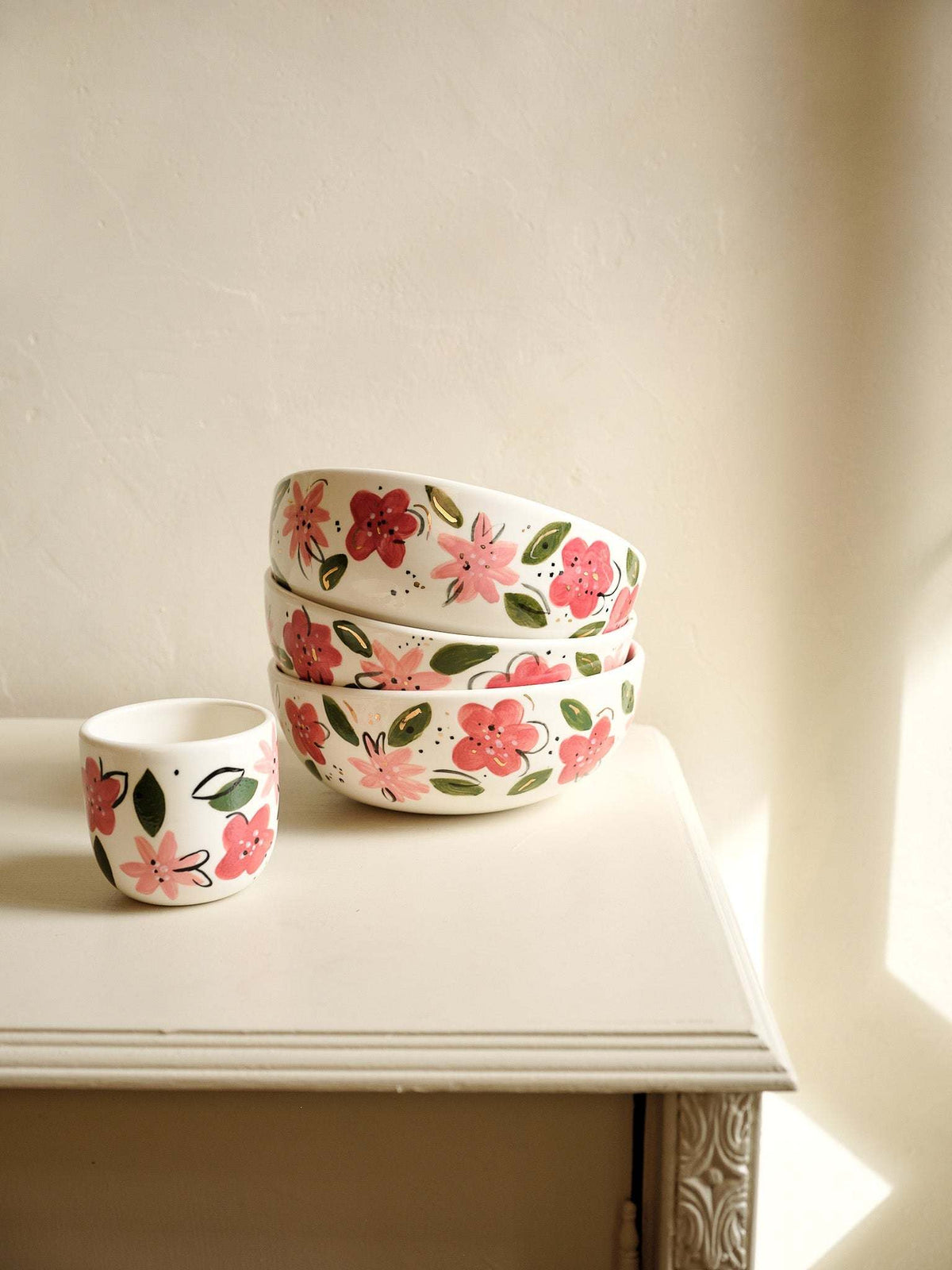 Hand-Painted Floral Coffee Cup in white porcelain, decorated with hand-painted pink and red flowers, green leaves, and gold accents.