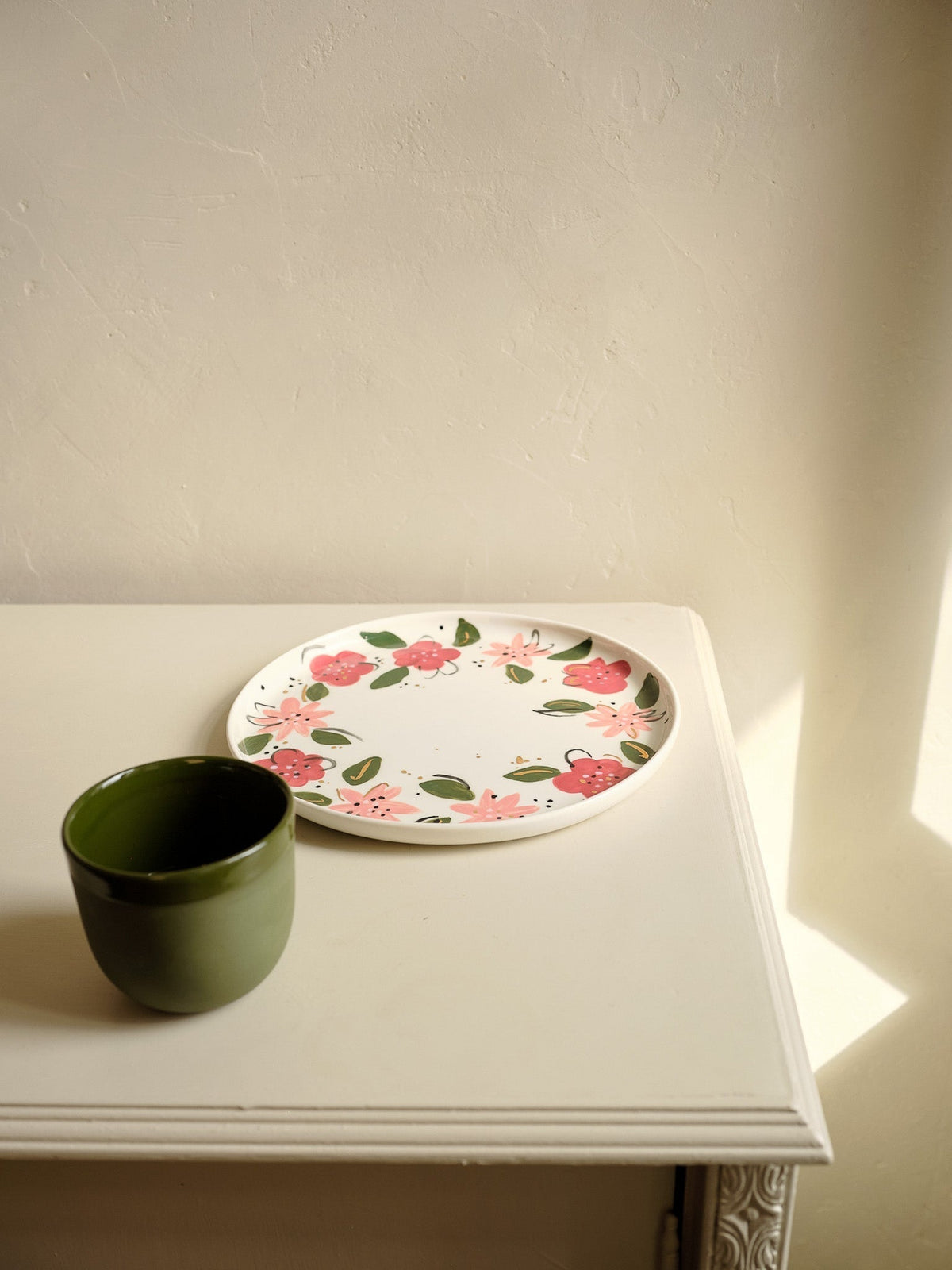 Hand-Painted Floral Dinner Plates: off-white porcelain plate with pink and red flowers, green leaves, and a gold rim.