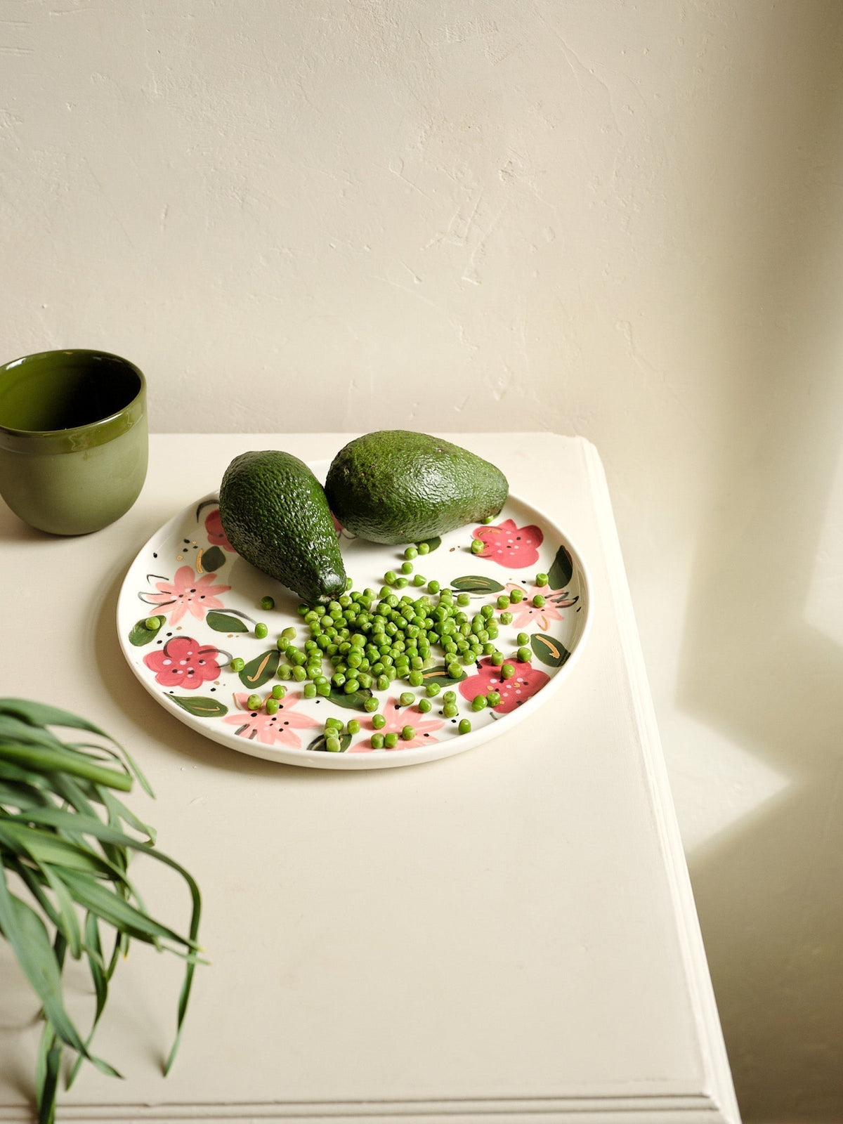 Hand-Painted Floral Dinner Plates, an off-white porcelain plate with hand-painted pink and red flowers, green leaves, and gold accents.